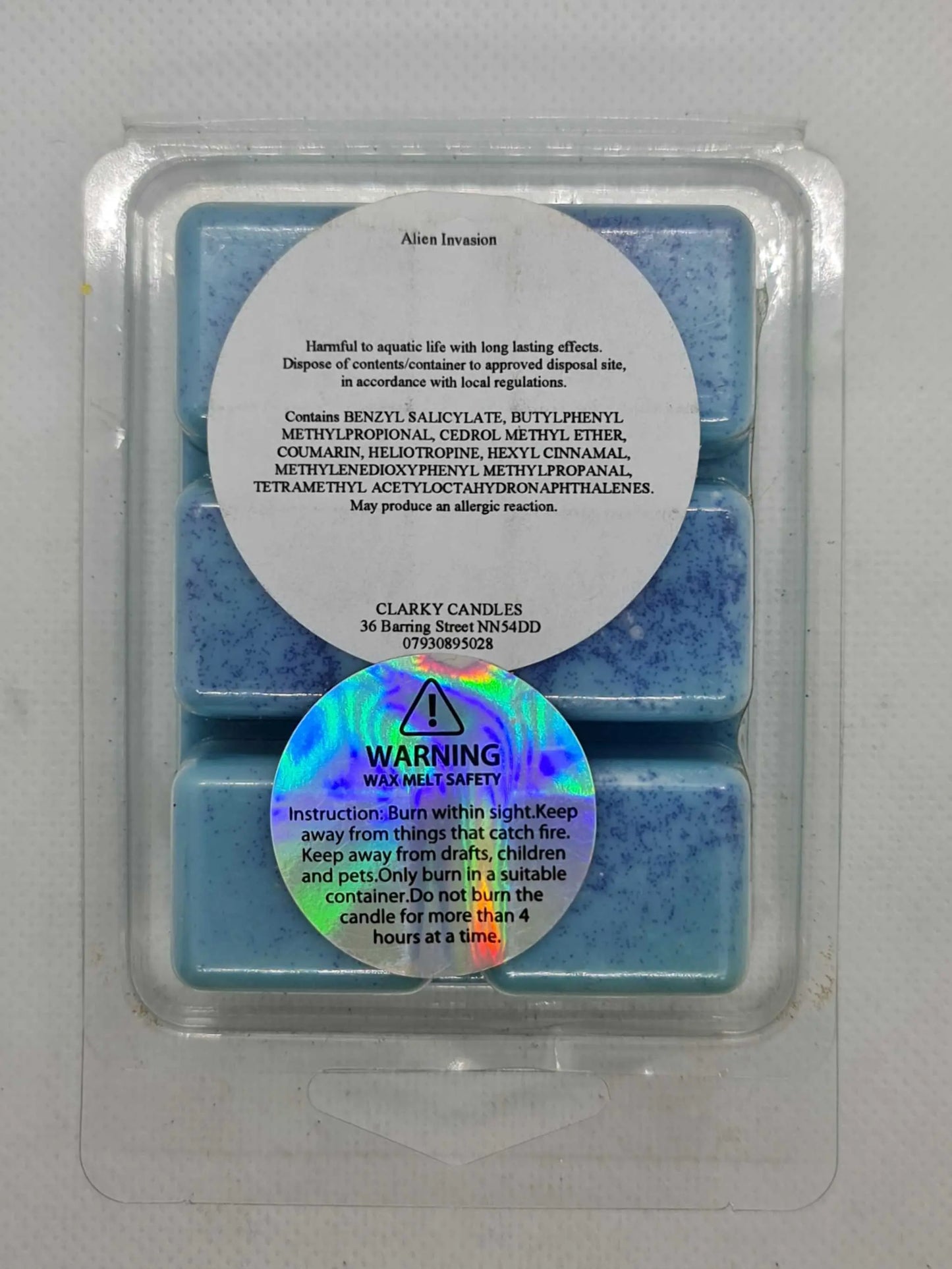 Alien Invasion Wax Melt by Clarky Candles, blue wax cubes with safety and ingredient labels, cosmic and otherworldly fragrance.