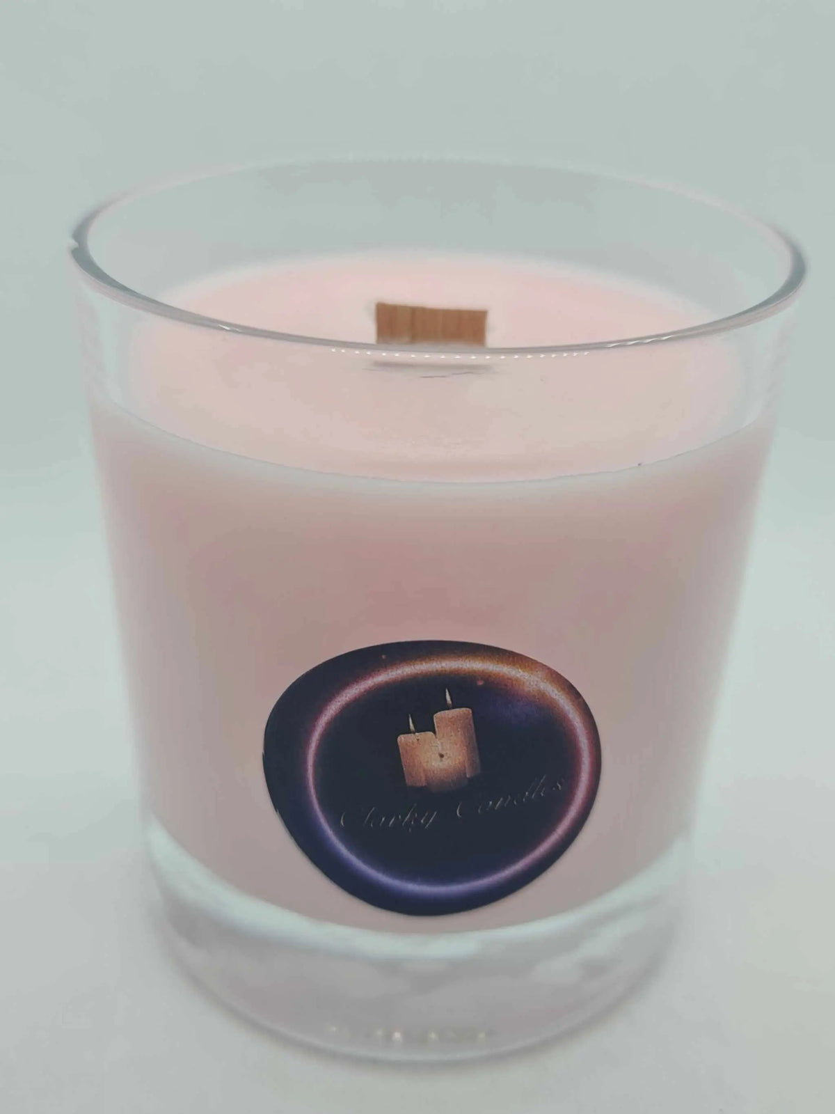 Velvet Rose & Oud scented pink soy wax candle with wood wick in clear glass container