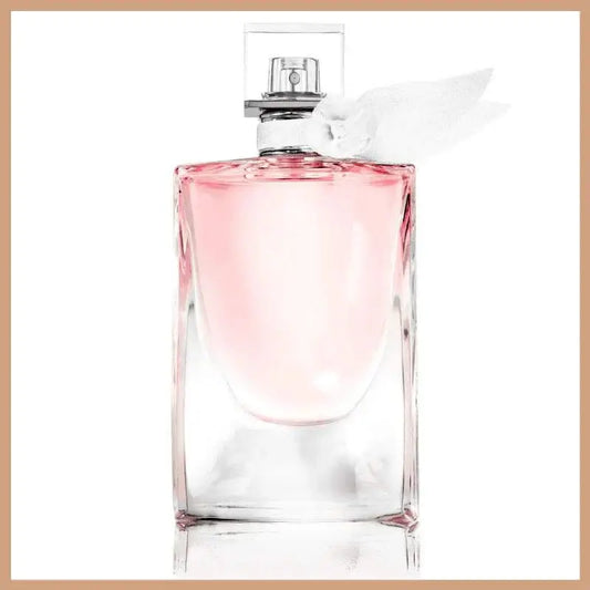 La Vie Est Belle scented soy wax candle with elegant feminine fragrance and pink liquid in clear glass bottle