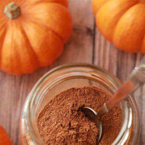 Pumpkin Spice Scented Sizzlers premium simmering granules with cinnamon and nutmeg fragrance in a jar with pumpkins background