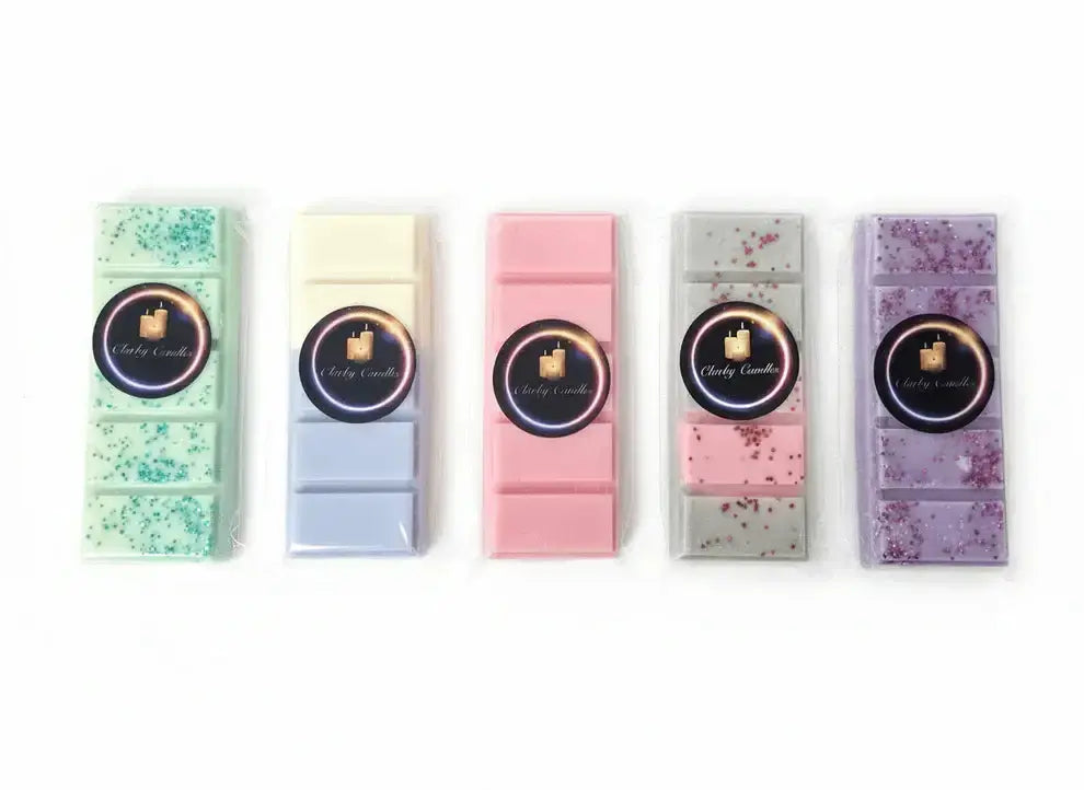 Variety of Clarky Candles wax melts in colorful snap bars, showcasing different scents and designs.