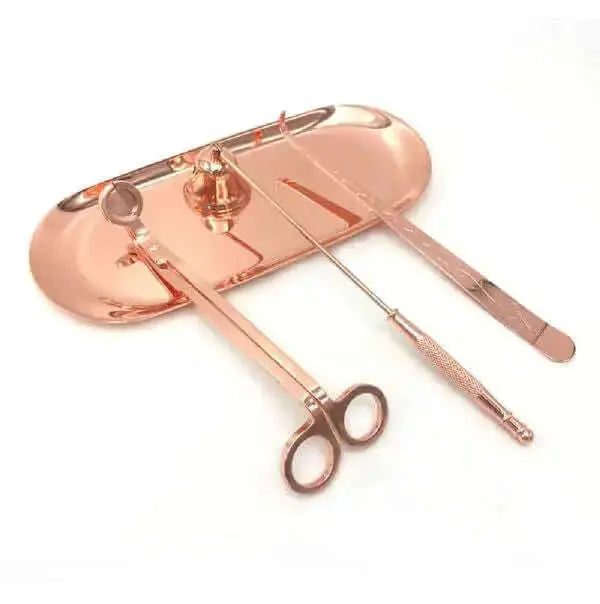 Essential care tools in a stylish rose gold set on a tray for candle enthusiasts.