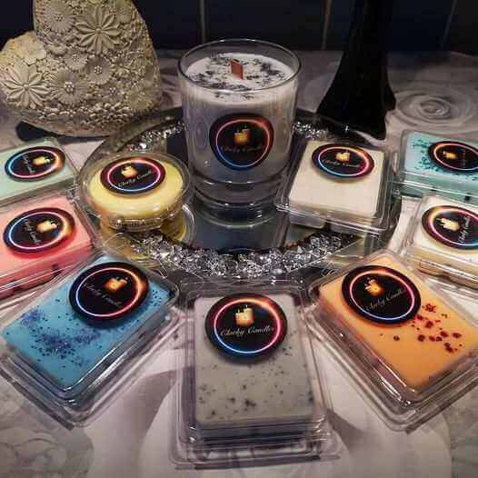 Discover Clarky Candles – Handcrafted luxury candles and wax melts in various fragrances arranged elegantly.