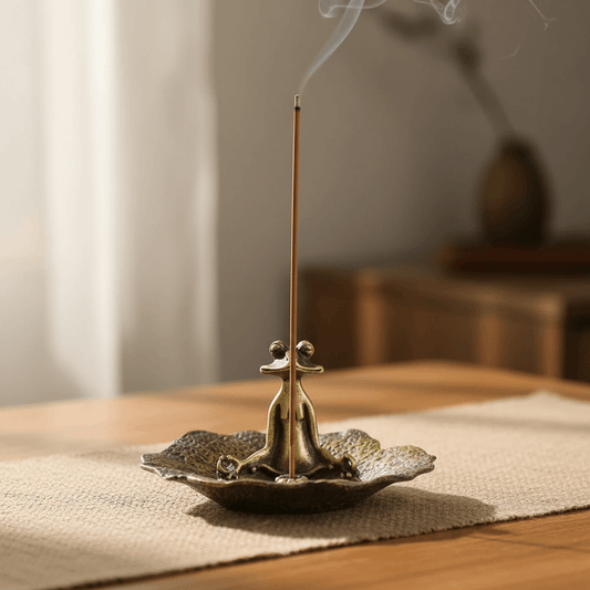 Frog on lotus leaf incense stick holder with incense stick burning and smoke